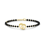 Load image into Gallery viewer, gold-baby-feet-nazariya-bracelet-with-black-beads-mgsbrc11612angle1-nl-yg