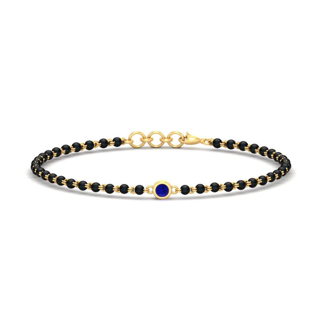 mens-single-bezel-set-sapphire-mangalsutra-bracelet-in-yellow-gold-mgsmbrc11836gsablangle1-nl-yg.jpg